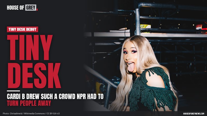 Cardi B smiling with long blonde hair in a green fringe dress