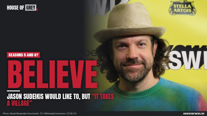 Jason Sudeikis smiling in a tan hat and tie-dye sweater at South by Southwest