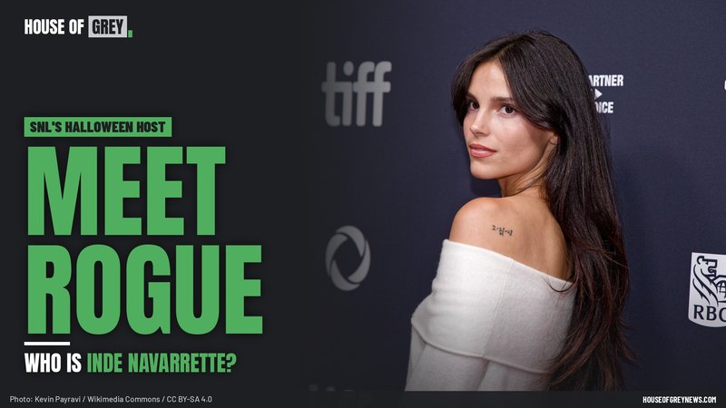 Inde Navarrette looking over her shoulder in a white off-the-shoulder top at the Toronto International Film Festival, beside the words MEET ROGUE