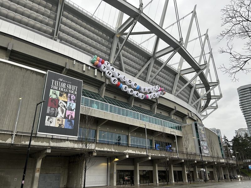 Giant friendship bracelet reading Taylor Swift The Eras Tour hung on a stadium