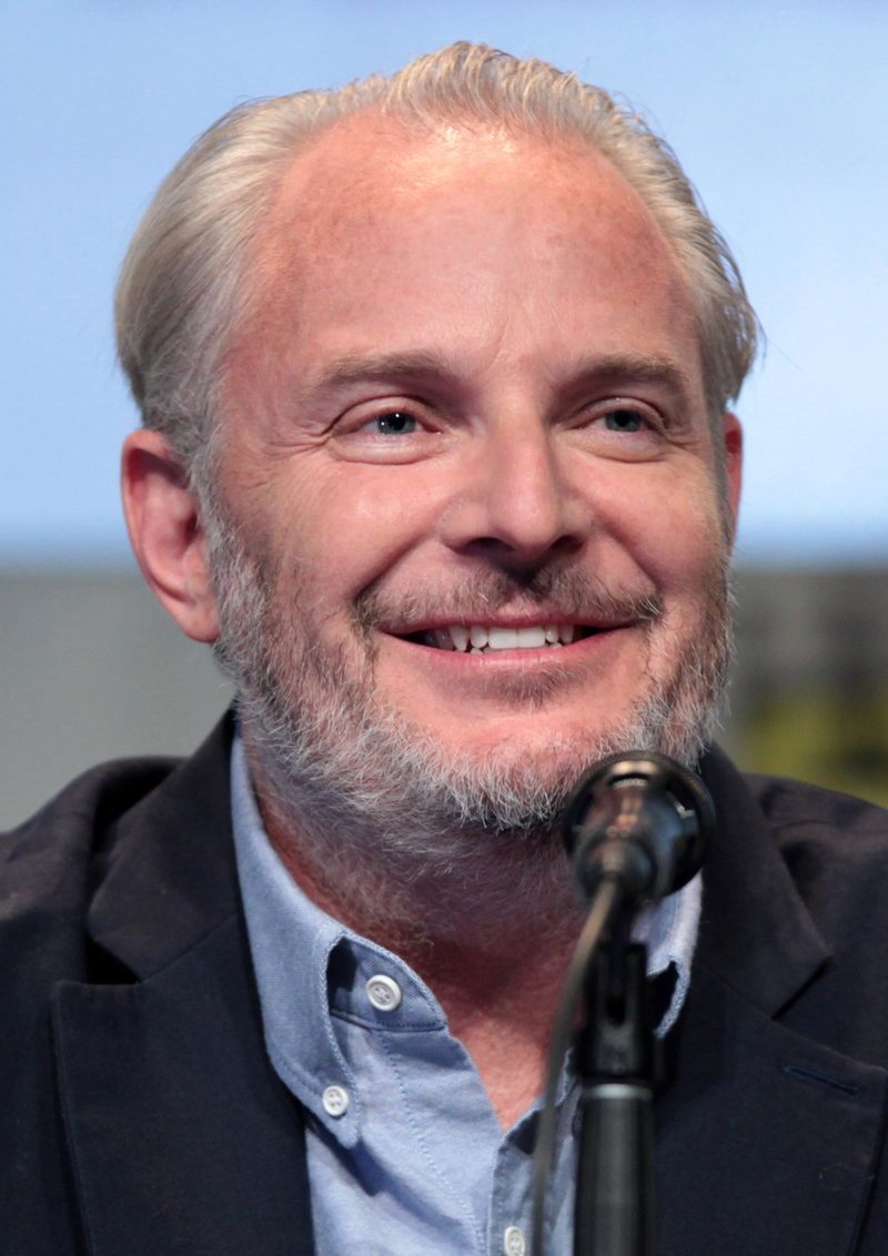 Francis Lawrence smiling at a Comic-Con panel microphone