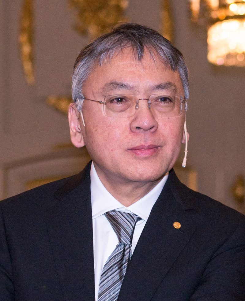 Kazuo Ishiguro in glasses, suit and tie