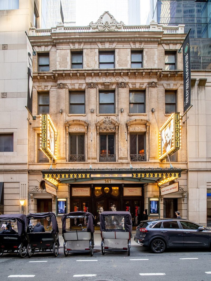 The ornate stone facade and marquee of the Hudson Theatre in Midtown Manhattan