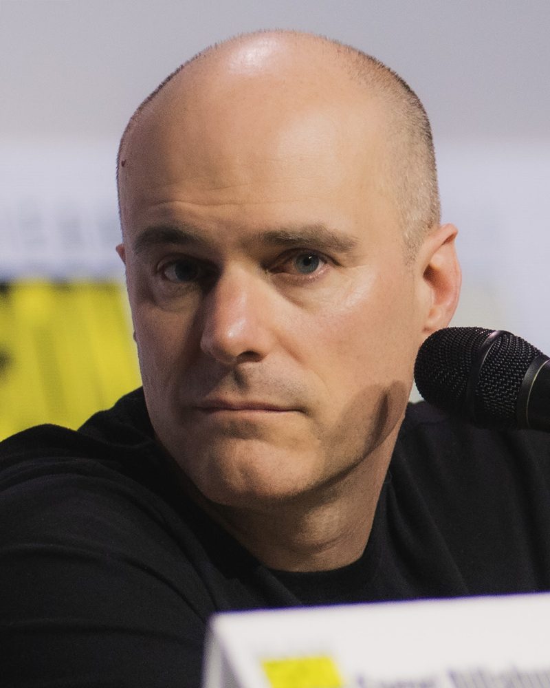 Tom King seated at a Comic-Con panel table with a microphone
